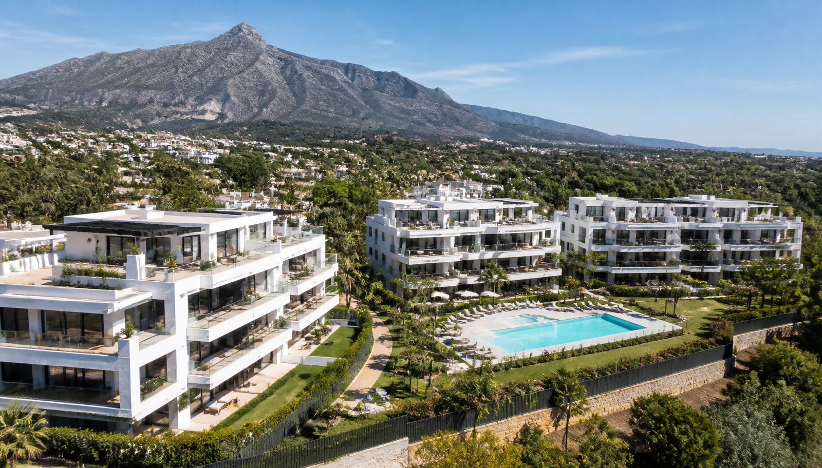 Recently completed low-rise residential apartment buildings with communal pool and landscaped gardens near Marbella