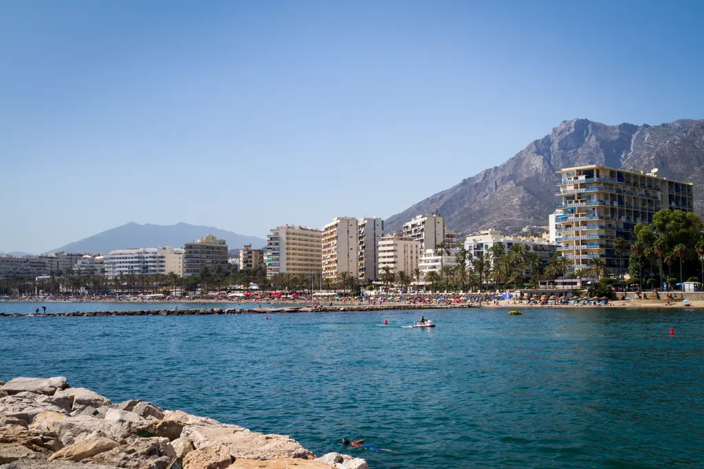 Apartment buildings along the Marbella seafront with La Concha mountain behind