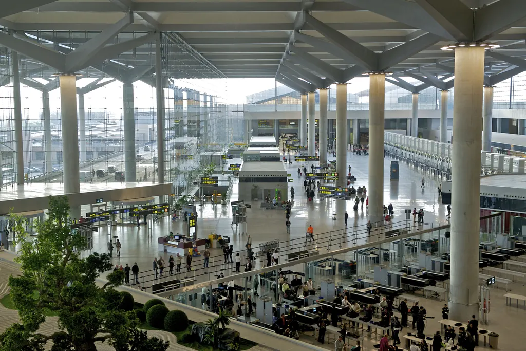 Departures hall of Terminal 3 at Málaga-Costa del Sol airport with travellers at the check-in desks